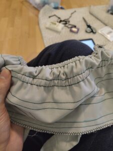 a close up of the process of the back shirring panel that uses elastic so it gets squished together.