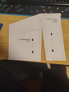 the correct pattern pieces of the center bodice and the side right next to each other. you can see the top third being close together while they seperate the further down you go.