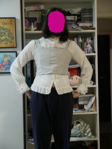 me test-fitting the widened bodice with a white lolita blouse. you can clearly see where I added a piece of fabric to wide the bodice.