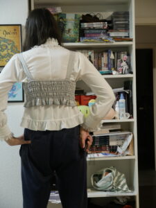 me test-fitting the widened bodice with a white lolita blouse. Its a shot from the back so you can see the shirring panel on the back.
