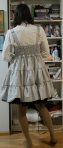 Its me wearing a white blouse and the done mpck-up JSK with a petticoat thats slightly too long so it peeks out under the JSK here is a shot from the back and you can see the shirring panel